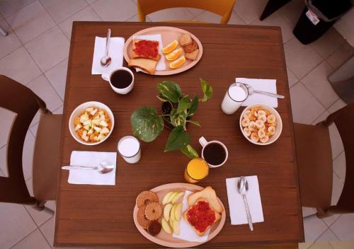 una mesa de madera con platos de comida. en Hotel del Bosque, en Torreón