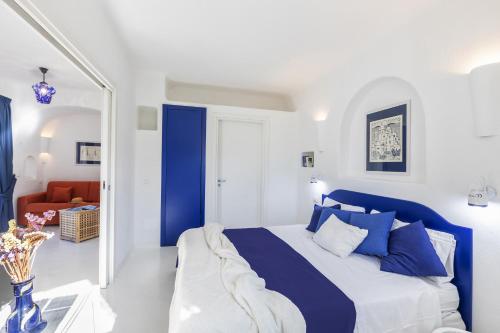 a blue and white bedroom with a bed and a chair at Villa Ravino Secret Retreat in Ischia