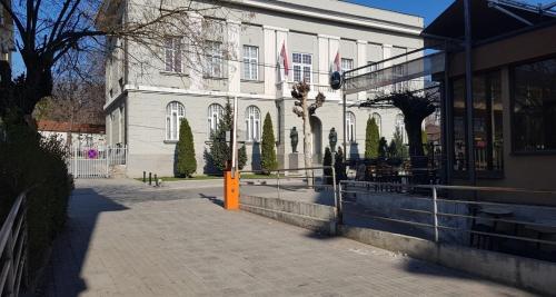 a white building with an orange box in front of it at Apartman Veselinovic Free PARKING in Vranje