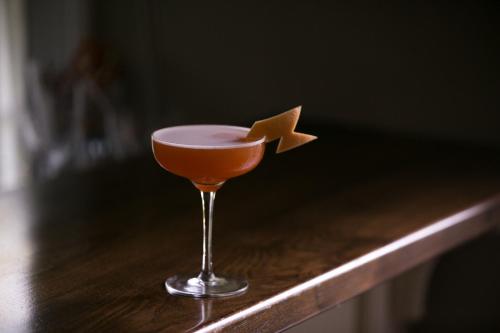 an orange cocktail with a star on a counter at Bridgehampton Inn in Bridgehampton