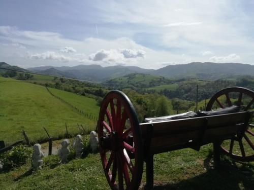 a cannon on a hill with mountains in the background at Agroturismo Pagoederraga in Orio