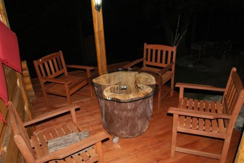 a group of chairs on a porch with a trash can at Rakhiv Plai in Rakhiv