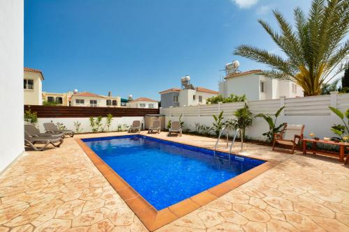 a swimming pool in the backyard of a house at Villa Nissi Gold in Ayia Napa