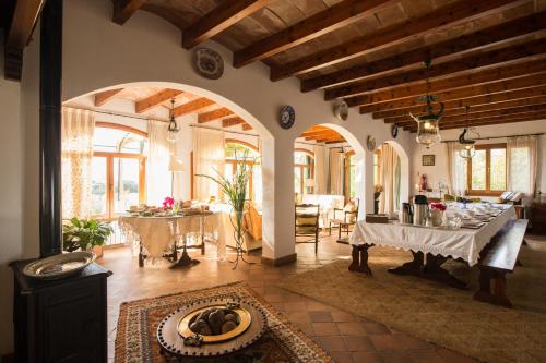 a living room with two tables and a dining room at Agroturismo Can Feliu in Porreres
