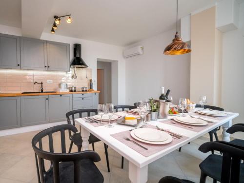a dining room with a white table and chairs at Holiday Home Amberg by Interhome in Kastav