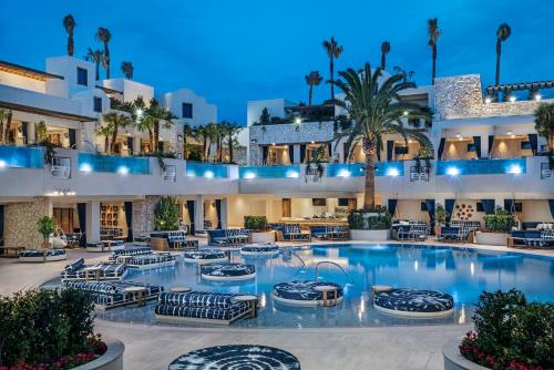 a hotel with a large pool with chairs and palm trees at Palms Casino Resort in Las Vegas