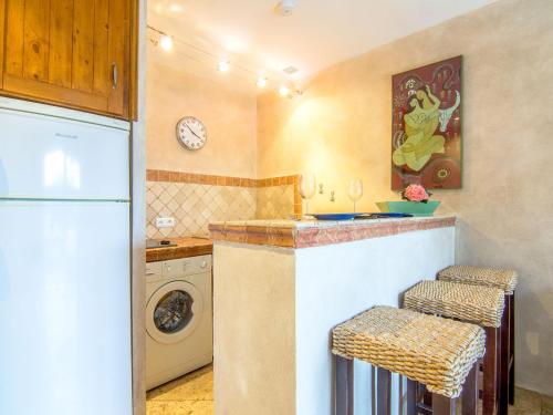 a kitchen with a sink and a washing machine at Apartment Les Carles by Interhome in Saint-Tropez