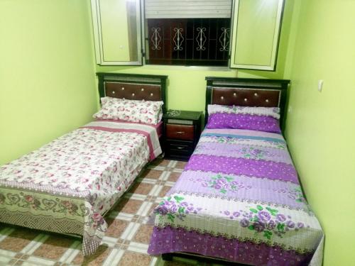 two beds sitting next to each other in a room at Mustapha 3 in Nador