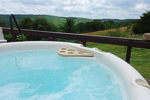 a jacuzzi tub on a deck with a view at StoneWind Retreat in Chester