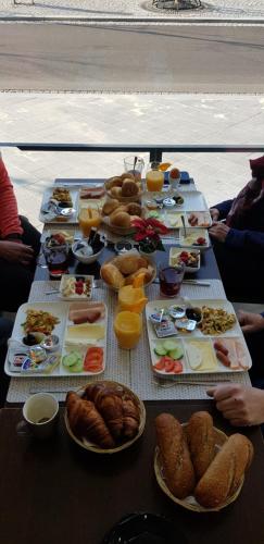 a table with a bunch of food on it at Hotel Sansa in Maastricht