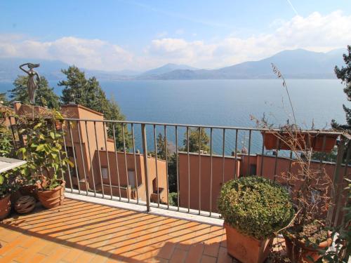 a balcony of a house with a view of the water at Apartment Residenza del Pascià by Interhome in Oggebbio