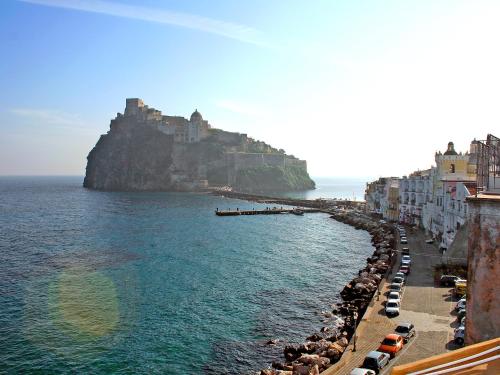 a view of a beach with buildings and the ocean at Apartment Lo Scuopolo-2 by Interhome in Ischia