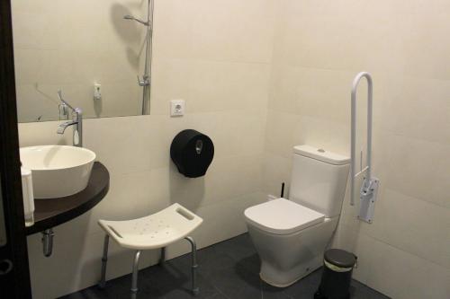 a bathroom with a toilet and a sink at TAKE SURF Hostel Conil in Conil de la Frontera
