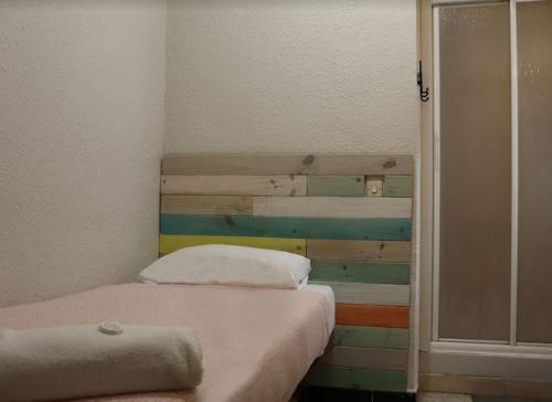 a bedroom with two beds and a wooden headboard at Pensión Fortea in Zaragoza