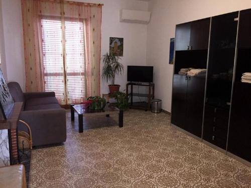 a living room with a couch and a tv at Casa Pierina in Alghero