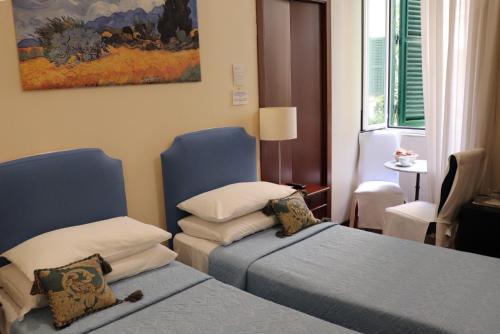 A bed or beds in a room at The Center Of Rome B&B