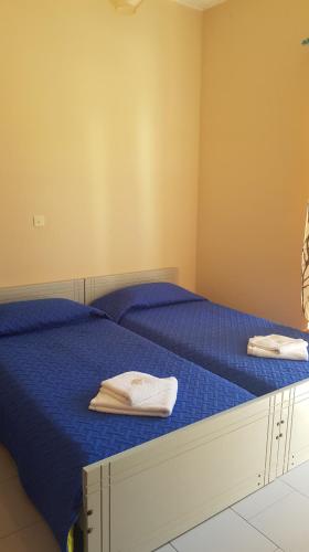 a bedroom with two beds with towels on them at Athina Apartments Tolo in Tolo