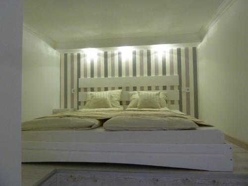 ein Schlafzimmer mit einem großen Bett mit Lichtern darauf in der Unterkunft Kossuth Apartmanok in Debrecen