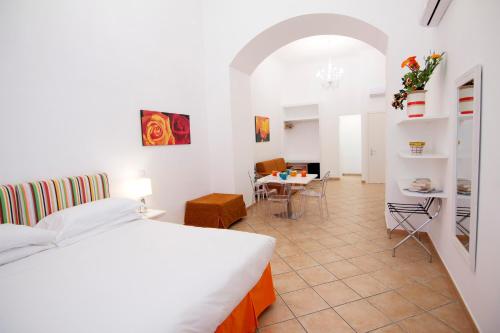 a bedroom with a bed and a dining room at Casa Sorrentina in Sorrento