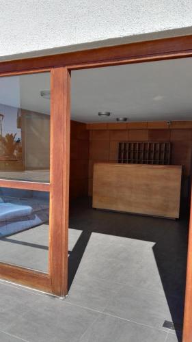 a sliding glass door of a room with aasteryasteryasteryasteryasteryasteryastery at Departamento en Condominio Costamar La Herradura in Coquimbo