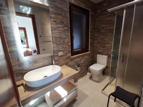 a bathroom with a sink and a toilet at Casa Fuile Cala Liberotto Orosei in Cala Liberotto