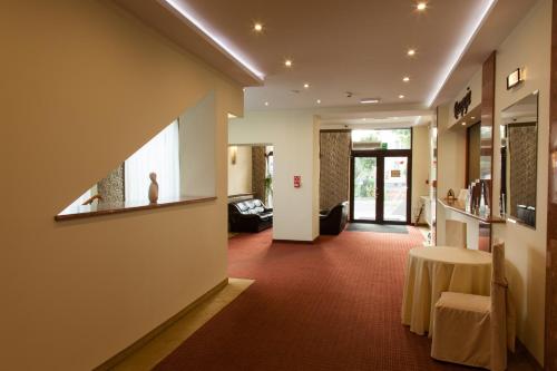 a hallway with a table in a room at Hotel Ostrawa in Wodzisław Śląski