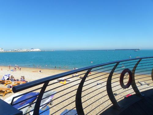 a view of a beach with people and the ocean at Maison Dieu Guest House in Dover