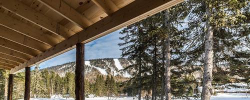 a view from the porch of a house in the snow at Le Ross in La Malbaie