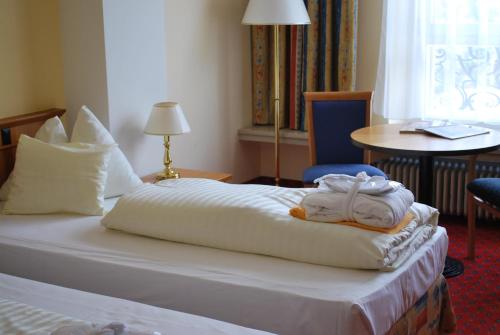 a hotel room with a bed with towels on it at Thermal Resort Hotel Elisabethpark in Bad Gastein