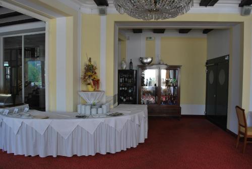 a white table in a room with a chandelier at Thermal Resort Hotel Elisabethpark in Bad Gastein