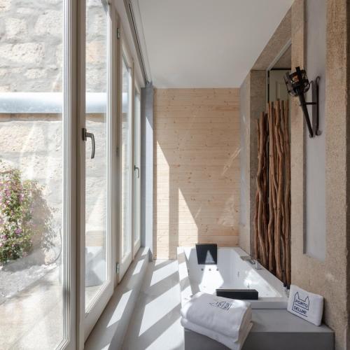 a bathroom with a sink and a large window at Porto Deluxe Apartments in Porto