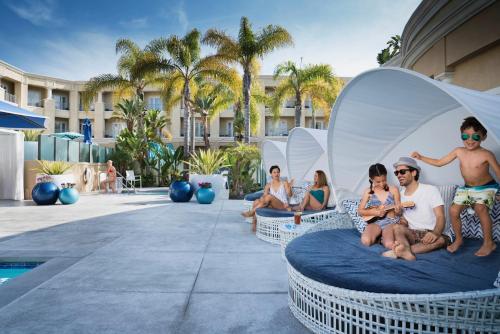 people sitting on top of a white bench at Balboa Bay Resort in Newport Beach