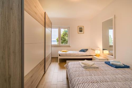 Кровать или кровати в номере Apartments Elza