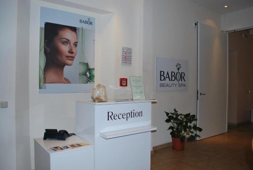 a white room with a poster of a woman on the wall at Thermal Resort Hotel Elisabethpark in Bad Gastein