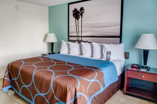 a bedroom with a large bed with two lamps at Super 8 by Wyndham St. Petersburg in St Petersburg