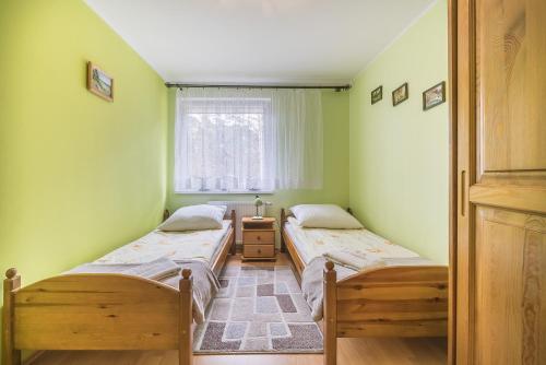 Posteľ alebo postele v izbe v ubytovaní Apartament Litoral Jurata