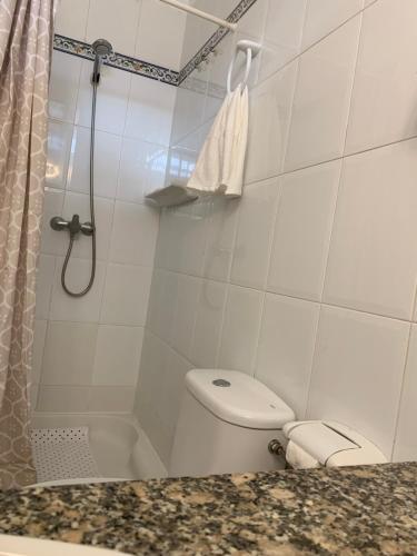 a white bathroom with a toilet and a shower at Dream Bahia in Santa Cruz de Tenerife