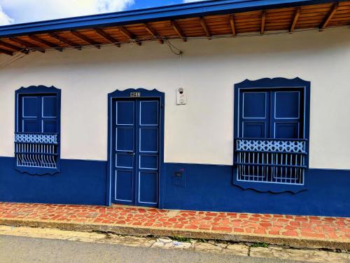 a blue and white building with two windows at Vivienda Turística - Casa de Carola in Jardin