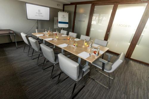 a conference room with a long table and chairs at Kolumna Park Hotel in Dobroń
