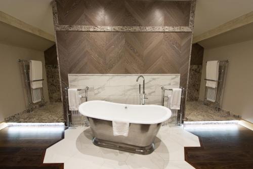 a bath tub in a bathroom with a wall at Fence Gate Lodge in Burnley