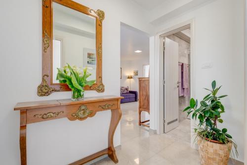 a mirror on top of a wooden table in a hallway at Apartments Jokica in Split