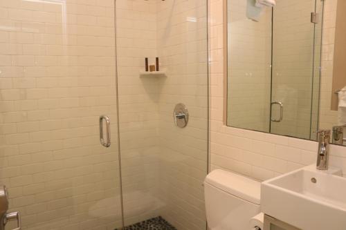 a bathroom with a shower and a toilet and a sink at Stylish Downtown Studio in the SouthEnd, C.Ave #24 in Boston