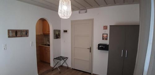 a hallway with a door and a chair in a room at Sunrise Apartments in Livadia