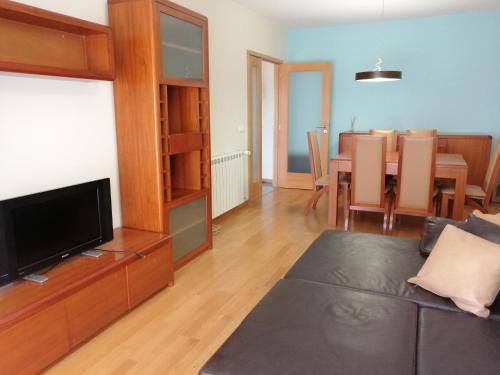 a living room with a couch and a dining room at Lemon Tree Apartment in Vila do Conde