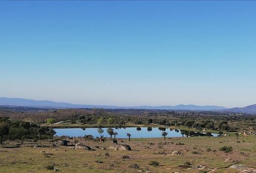 a lake in the middle of a field at Apartamento Zocailla Suite in Gata