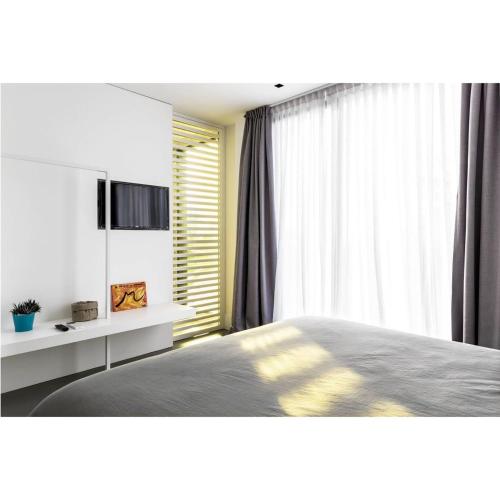a bedroom with a bed and a large window at Masseria Guida in Ercolano