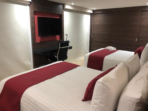 Postel nebo postele na pokoji v ubytování MC Suites Mexico City