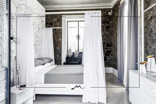 a bedroom with a canopy bed with a mirror at Masseria Guida in Ercolano