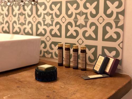 four bottles of essential oils on a counter next to a sink at The Houses of History - anno 1830 in Tihany