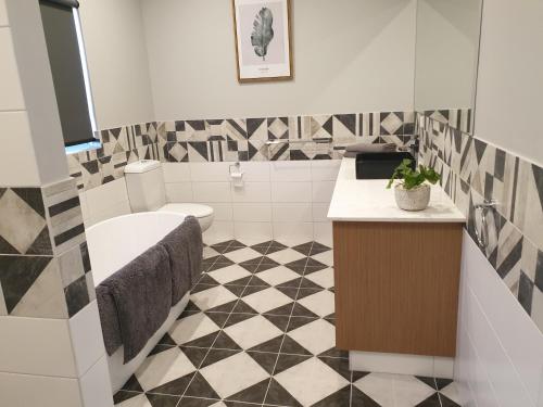 a bathroom with a toilet and a sink at River Retreats Kalbarri in Kalbarri
